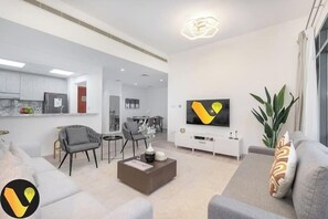 Luxury Apartment, Balcony, City View | Living area | 65-inch Smart TV with cable channels - Vogue Greens near Emirates Mal Ski Dubai (Dubai)