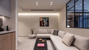 A modern living room with a sofa, a coffee table, and a minimalist design.