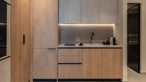 A modern kitchen with wooden cabinets, a countertop, and a built-in sink.