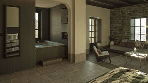 A modern bathroom with a large bathtub, a shower, and a vanity. There is a seating area with a sofa and a table.
