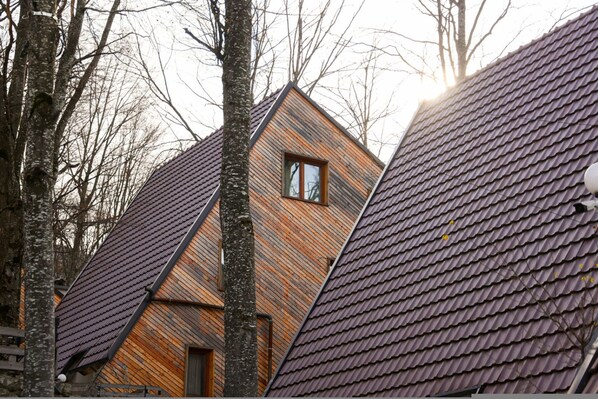 A modern house with a sloped roof and a visible window.