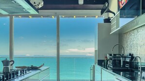 A modern kitchen with a view of the ocean. - Stunning mansion in Joatinga, Rio de Janeiro. (Rio de Janeiro)