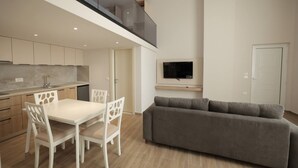 Eine moderne Wohnung mit Küche, Essbereich und Wohnzimmer.