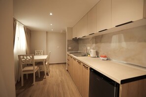 A modern kitchen with wooden cabinets, a sink, and a dishwasher. - Duplex City 06/07 in Durrës (Durrës)