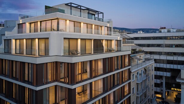 A multi-story hotel with a modern design, featuring balconies, large windows, and a rooftop terrace. - September Athens Residences (Athens)