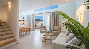 A modern living room with a sofa, chairs, a coffee table, and a staircase. - Lirides 2 bedroom Suite B2  with loft (Lefkada)
