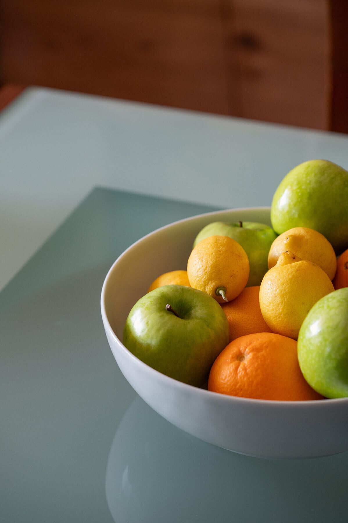 Un frutero con fruta sobre una mesa.
