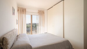 A bedroom with a large window, a bed, and a view of the outside. - Gimber Lofts 2 by Klodge- vintage flat with Wi-Fi (Olbia)