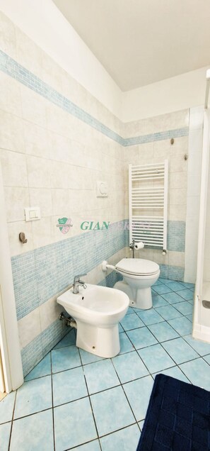 A bathroom with two toilets, a sink, and a towel rack. - One-Bedroom Apartment for 4 Guests  Ref.Casa Sissy-Rif. Casa Sissy (San Vincenzo)