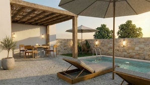 Un área junto a la piscina con sillas de descanso, una mesa y una sombrilla.