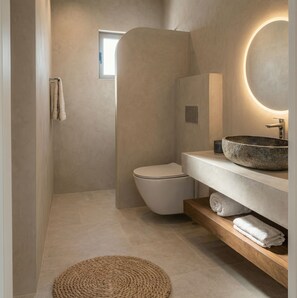 A modern bathroom with a stone sink, a toilet, and a round mirror with a light. - Villa Michael with Swimming pool (Agriana)