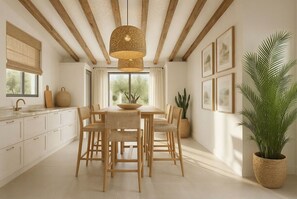A modern kitchen with wooden beams, a large window, and a dining area with wicker chairs and a central island. - Villa Olia with Swimming pool (Agriana)