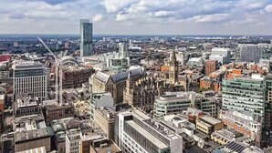 A cityscape with a mix of modern and historic buildings, including a prominent skyscraper and various architectural styles. - 1-bed Apt, Sleeps 4, Old Trafford Nearby (Manchester)