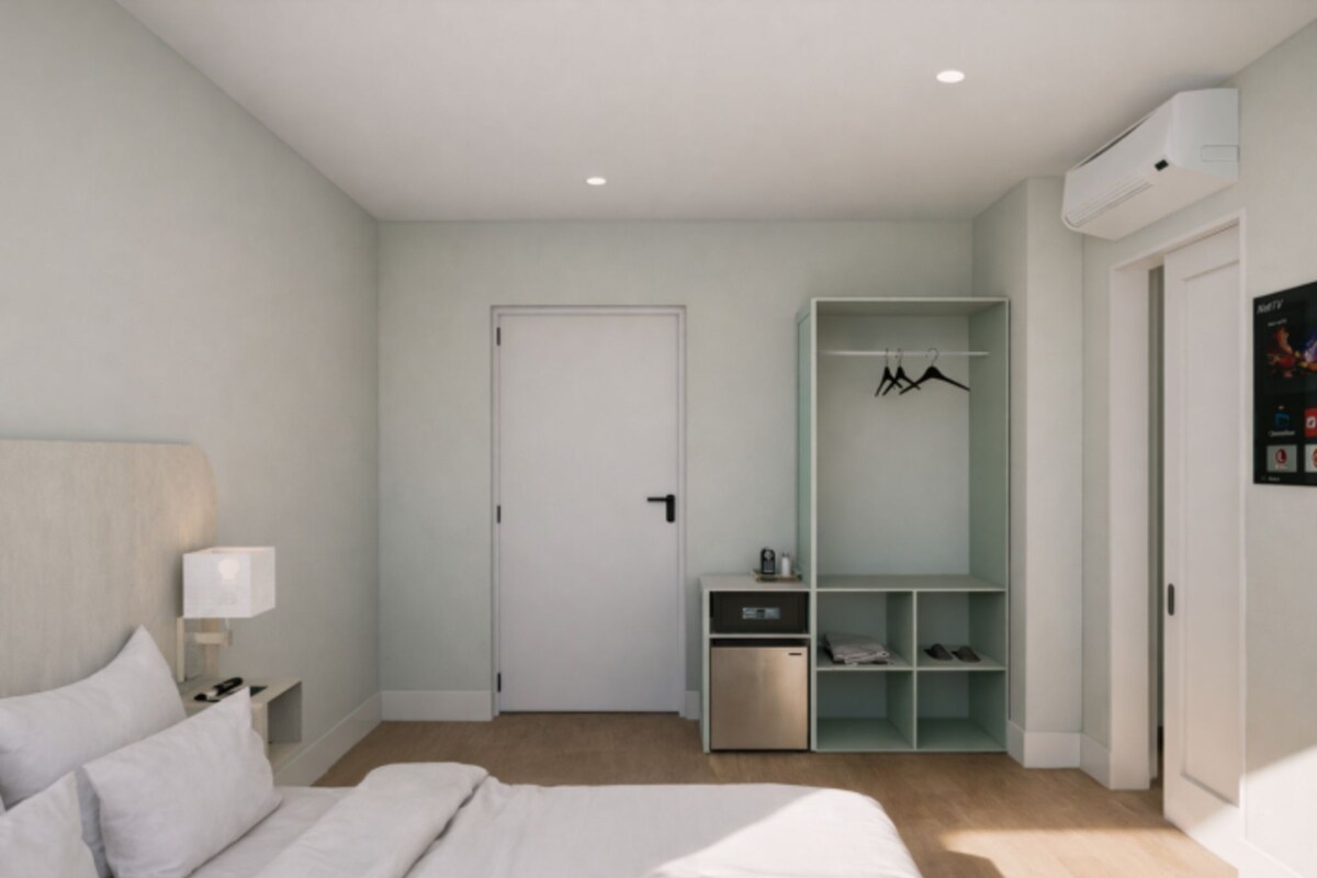 A modern bedroom with a bed, bedside table, wardrobe, and built-in shoe storage.