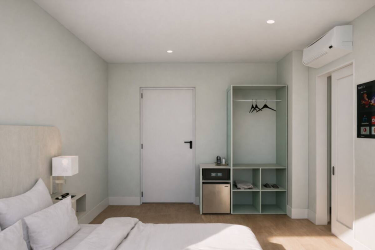Un dormitorio moderno con cama, mesita de noche, armario y espacio para guardar zapatos integrado.