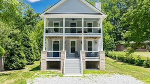 A two-story house with a front porch, a chimney, and a number "2626" on the front. - Charming 3BR w Balconies Walk to Flat Rock Playhouse (Flat Rock)