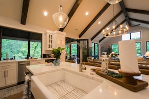 Una cocina amplia con una isla grande, electrodomésticos modernos y vistas al exterior.