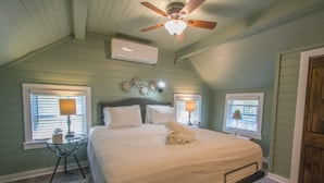 A bedroom with a bed, two bedside lamps, a ceiling fan, and a window with blinds. - Rustic 3BR w Private Pond Firepit Near Trails (Hendersonville)