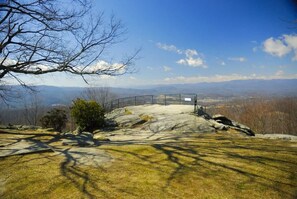 A rocky landscape with a metal fence and a viewing platform. - Charming 2BR Townhouse w Patio Walk to Main St (Hendersonville)
