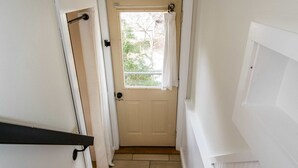 A wooden staircase leading to a white door with a window above it. - Dog Friendly Tiny House On Lake Lure Private Dock (Lake Lure)