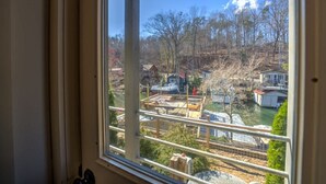 A view from a window overlooking a construction site with buildings and trees. - Dog Friendly Tiny House On Lake Lure Private Dock (Lake Lure)