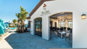 A bar and lounge named "Tu Casa" with outdoor seating and a pool area in the background. - Go 17 Windsor at Westside (Kissimmee)
