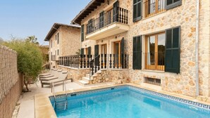 A stone building with a swimming pool, a balcony, and a staircase leading to the entrance. - House "Valldemossa Paradise". (Valldemossa)
