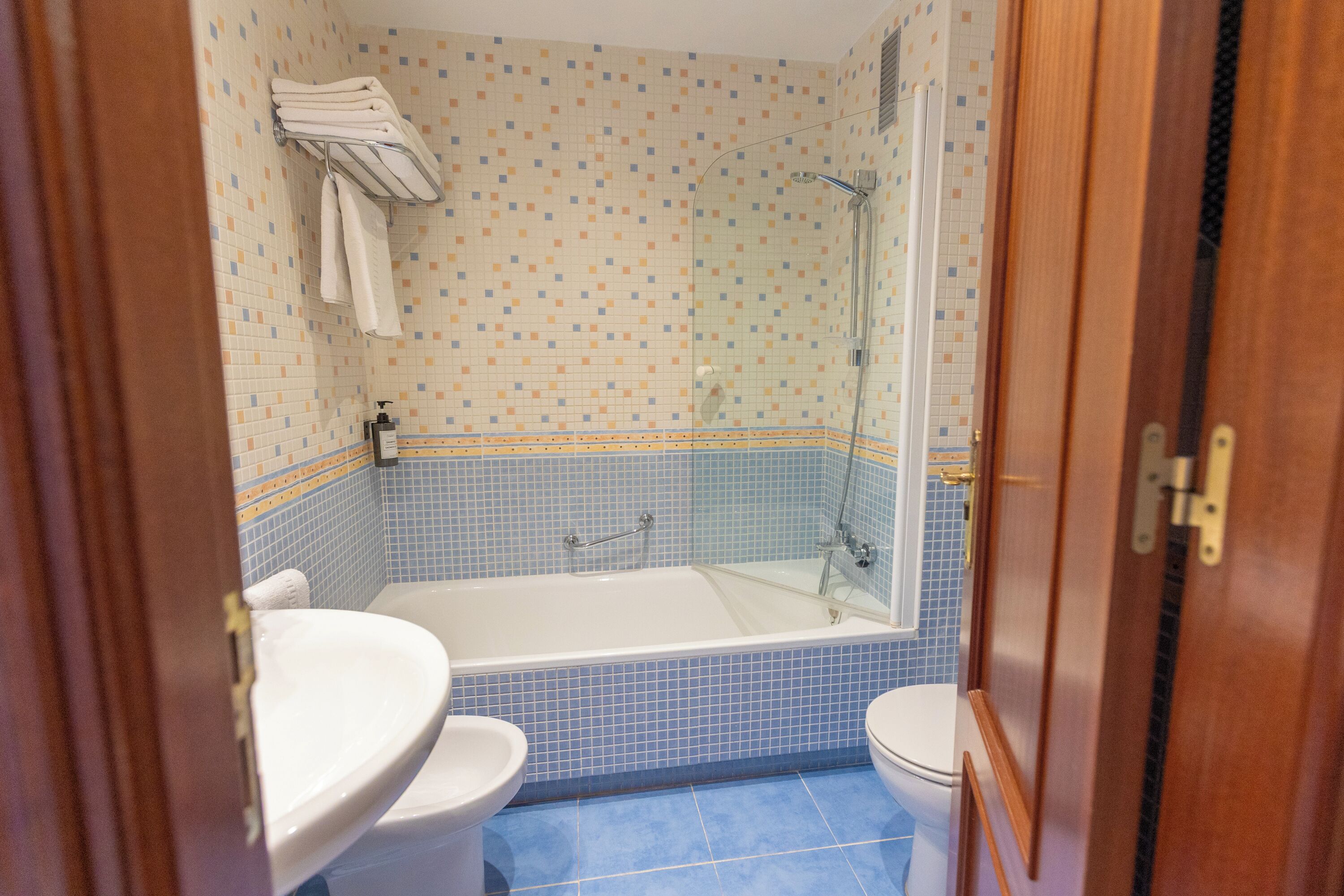 A bathroom with a bathtub, toilet, and sink.