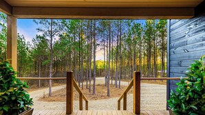 A wooden deck with a view of a forest. - Fall Promo! Luxe & Kid Approved! Playset, EV (Broken Bow)