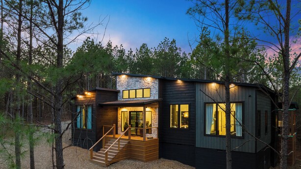 A modern cabin with a stone facade, wooden deck, and large windows. - Fall Promo! Luxe & Kid Approved! Playset, EV (Broken Bow)