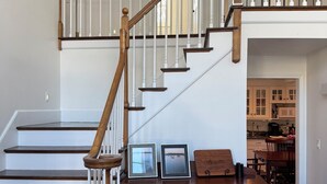 A staircase with wooden railings and white balusters, leading to an upper level. - World Cup Stay in Easton! Elegant Suburban Escape Close to Boston Excitement (Easton)