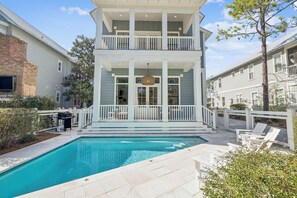 A two-story building with a pool and outdoor seating. - Anna Blue| Watercolor | Private Pool | Bikes (Watercolor)