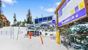 A ski lift station with a sign for Snowflake Lift, a covered waiting area, and a chairlift. - New Listing! Ski In/Walk to the Lift (Breckenridge)