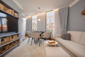 Apartamento superior, vistas a la ciudad | Zona de estar | Una televisión de pantalla plana