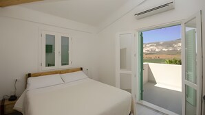 A bedroom with a bed, a window with a view, and an air conditioning unit. - Villa Degli Alberi with Garden, Private Terrace, Wi-Fi and Air Conditioning (Buseto Palizzolo)