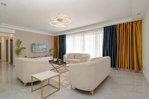 Deluxe Apartment, Balcony, City View | Living area | 32-inch Smart TV with digital channels - Royal Oaks Residency (Nairobi)