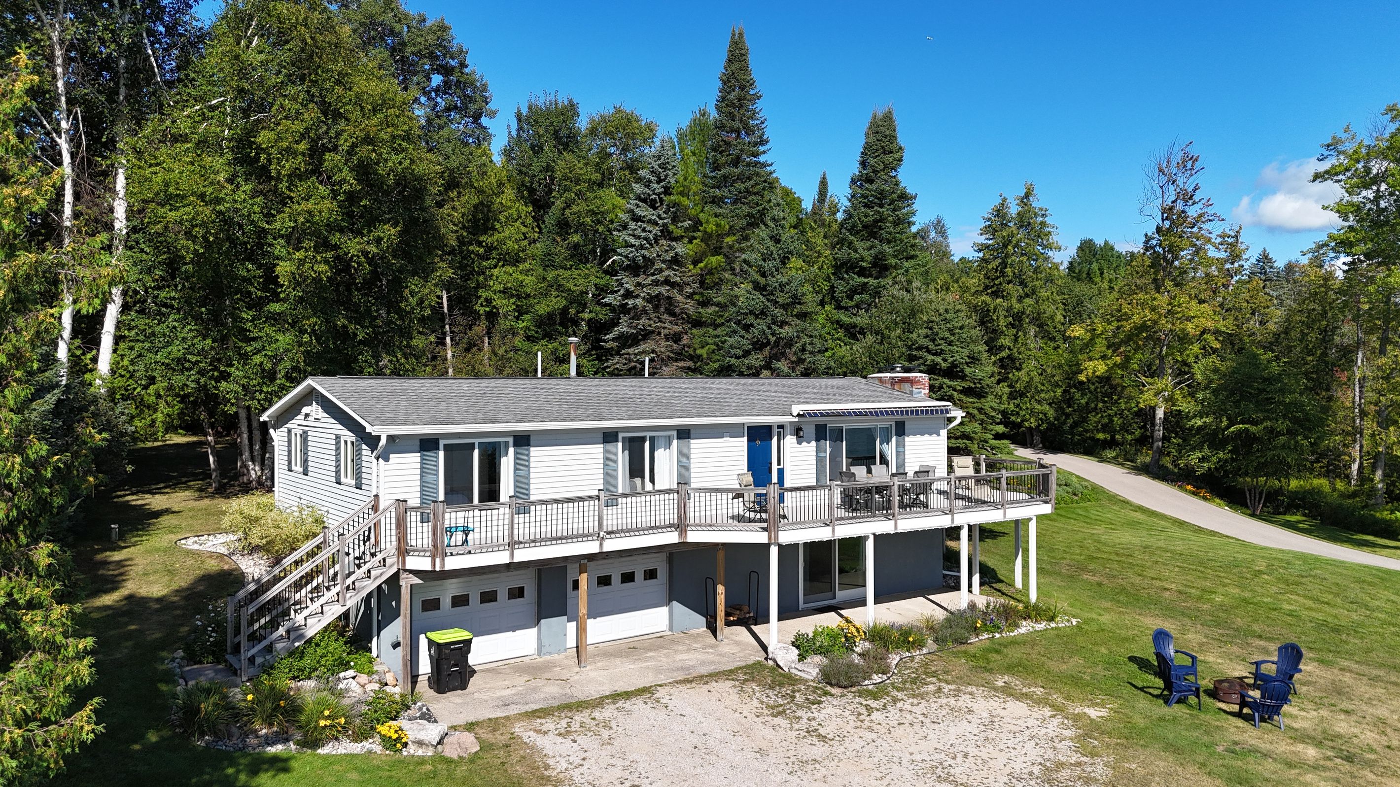 A two-story house with a balcony, a garage, and a driveway.