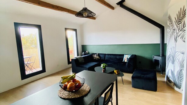 A modern living space with a dining area, a sofa set, and a large window. - Superb architect-designed apartment with magnificent view of Marseille (Marseille)