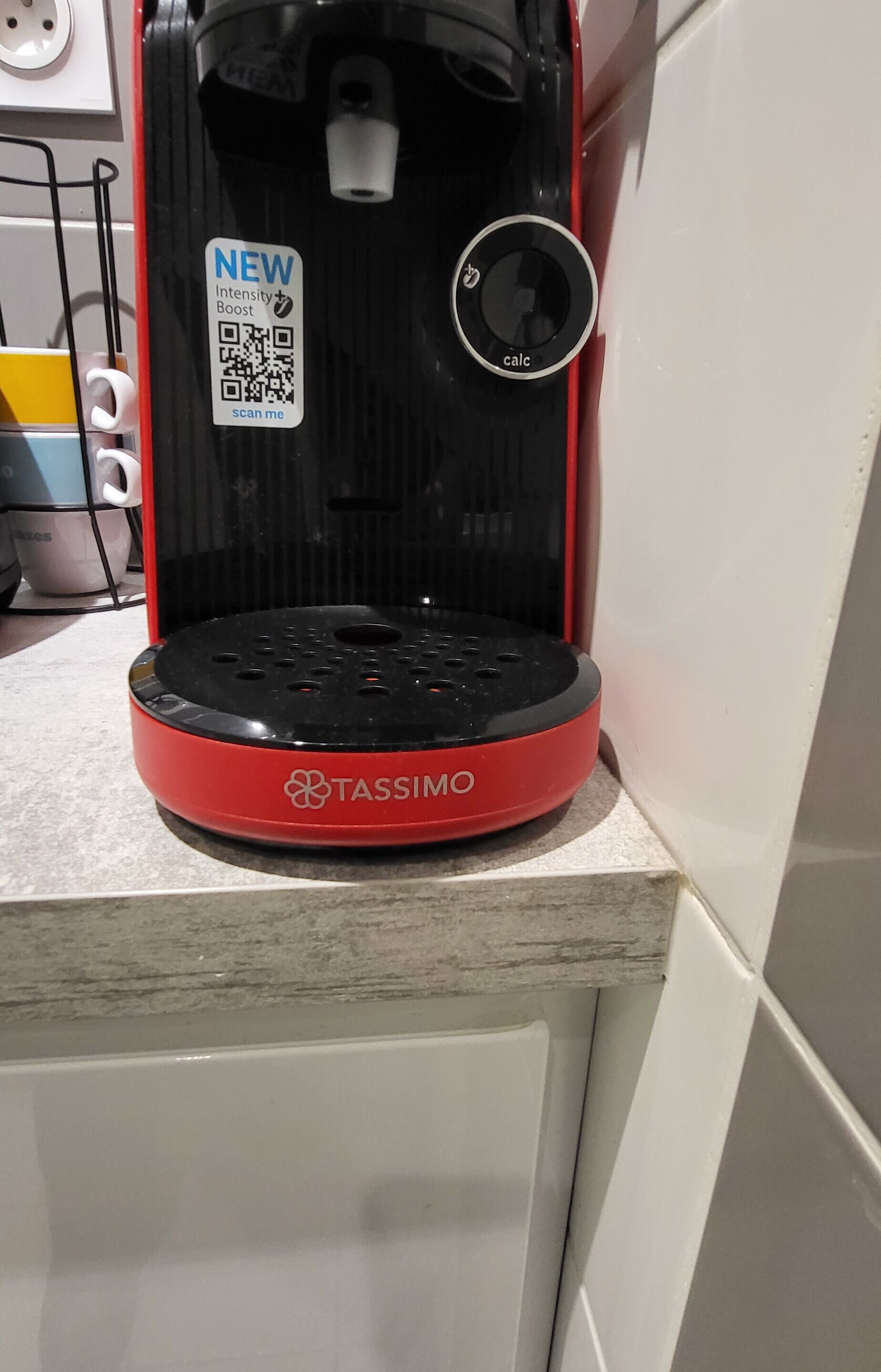 A Tassimo coffee machine with a new intensity boost sticker, a QR code, and a dial.