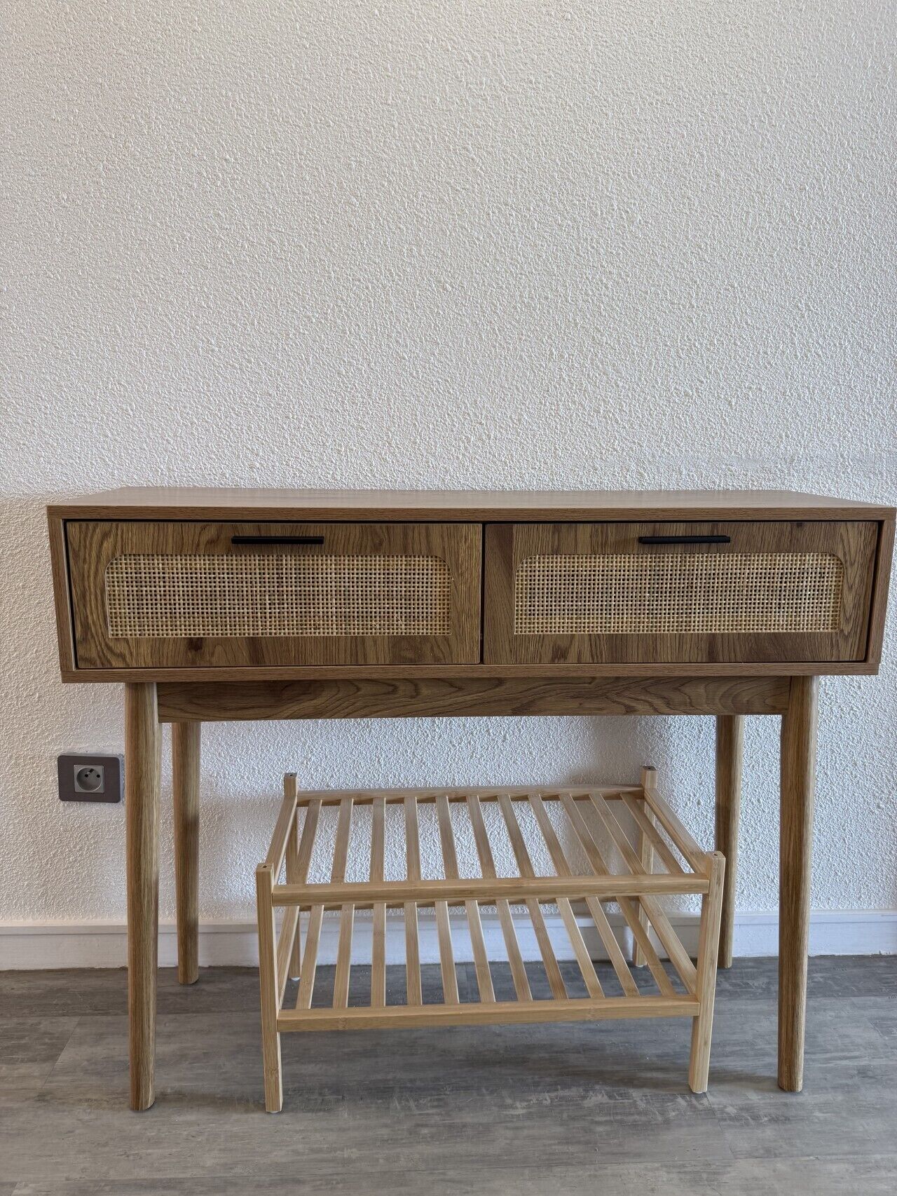 A wooden desk with two drawers and a shelf.