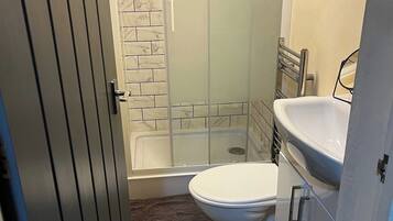 Combined shower/bathtub, deep-soaking bathtub, hair dryer, towels