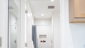 A modern bathroom with a shower, toilet, and sink. - Brand-New Furnished Studio ADU for Mid-Term Stays (San Mateo)