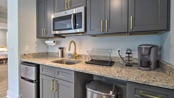 Fridge, microwave, coffee/tea maker, cookware/dishes/utensils