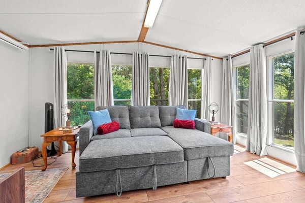 This is hands-down my favorite spot in the house. Sunlight pours in through the windows. The pop-up sofa transforms into a comfy full bed (linens provided) The vintage record player is ready to spin your favorite tunes. This room is pure relaxation.