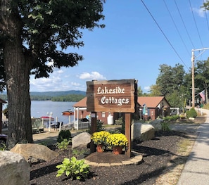 A wooden sign for Lakeside Cottages with a view of a lake and cabins. - Lakefront Cottage #5 | Dock | Mtn & Lake Views (Bristol)