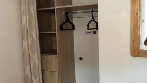 A walk-in closet with wooden shelves, a hanging rod, and a door marked "PRIVÉ". - 4/5-person apartment at the foot of the slopes (Risoul)