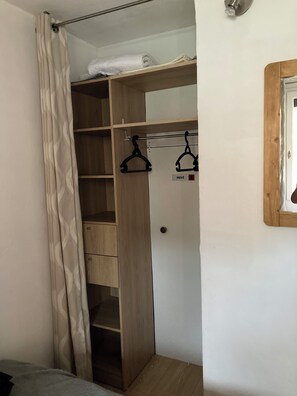 A walk-in closet with wooden shelves, a hanging rod, and a door marked "PRIVÉ". - 4/5-person apartment at the foot of the slopes (Risoul)