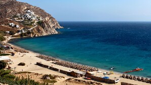 A coastal village with white buildings on a hillside, a sandy beach, and the sea. - Amazing view Mykonian Villa with 5 bedrooms and pool (Mykonos)