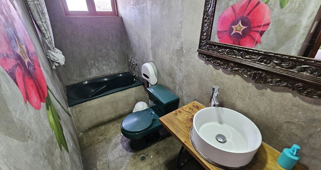 A small bathroom with a toilet, a sink, and a bathtub.