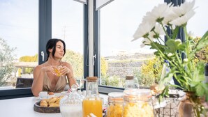 A breakfast table with pastries, condiments, and a view of a natural landscape. - DIAMOND 4BD Villa Pool & HotTub Sea/Sunset View (Santorini)